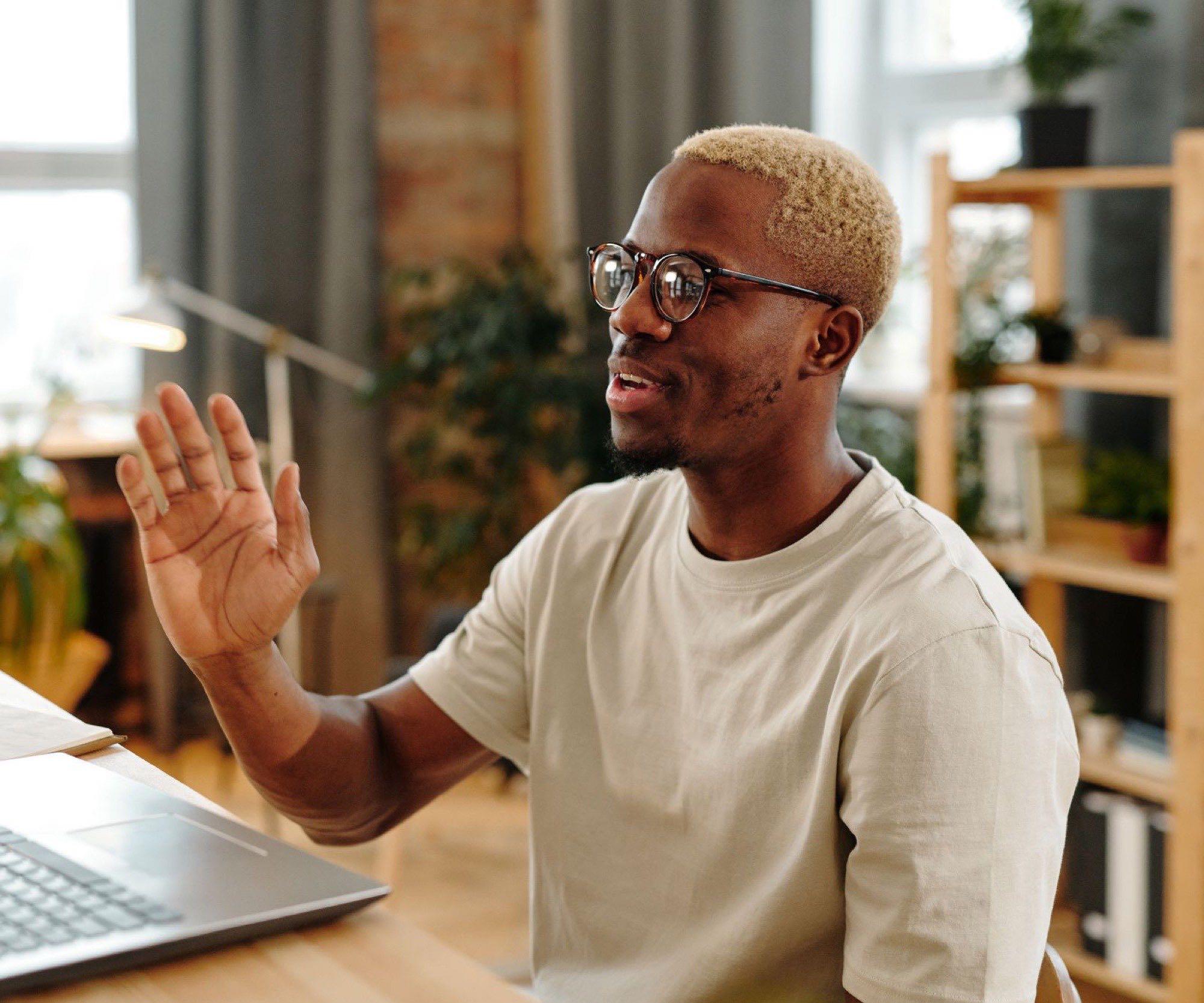 Patient at home talking with their clinician over a laptop video visit